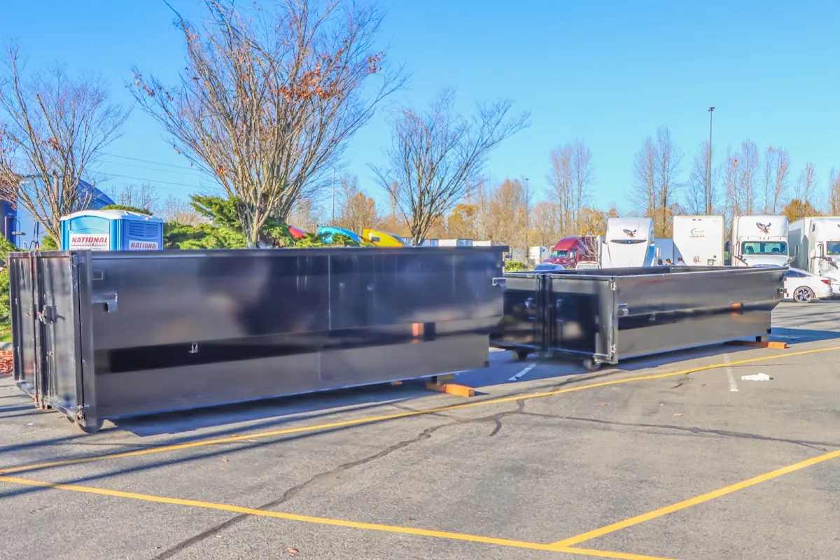 Professional dumpster rental service with roll-off container on residential driveway in Southbury